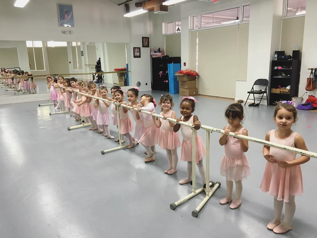 Young dancers learning together at the barre at Miami Royal Ballet, Coral Gables